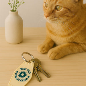 More Cats, Less Cat Calling Keychain
Equal parts protest and purr.

A retro motel-style tag with zero tolerance for street sleaze. Molded in buttercream plastic with a punch of deep green text and a bold daisy, it says what you’re thinking: MORE CATS, LESS CAT CALLING.

Clip it to your keys like brass knuckles for the modern feminist.  Fierce, unapologetic, loud, feral and decidedly not here for your unsolicited commentary.
	•	3.8” x 2” vintage motel shape
	•	Chunky molded plastic with raised lettering
	•	D